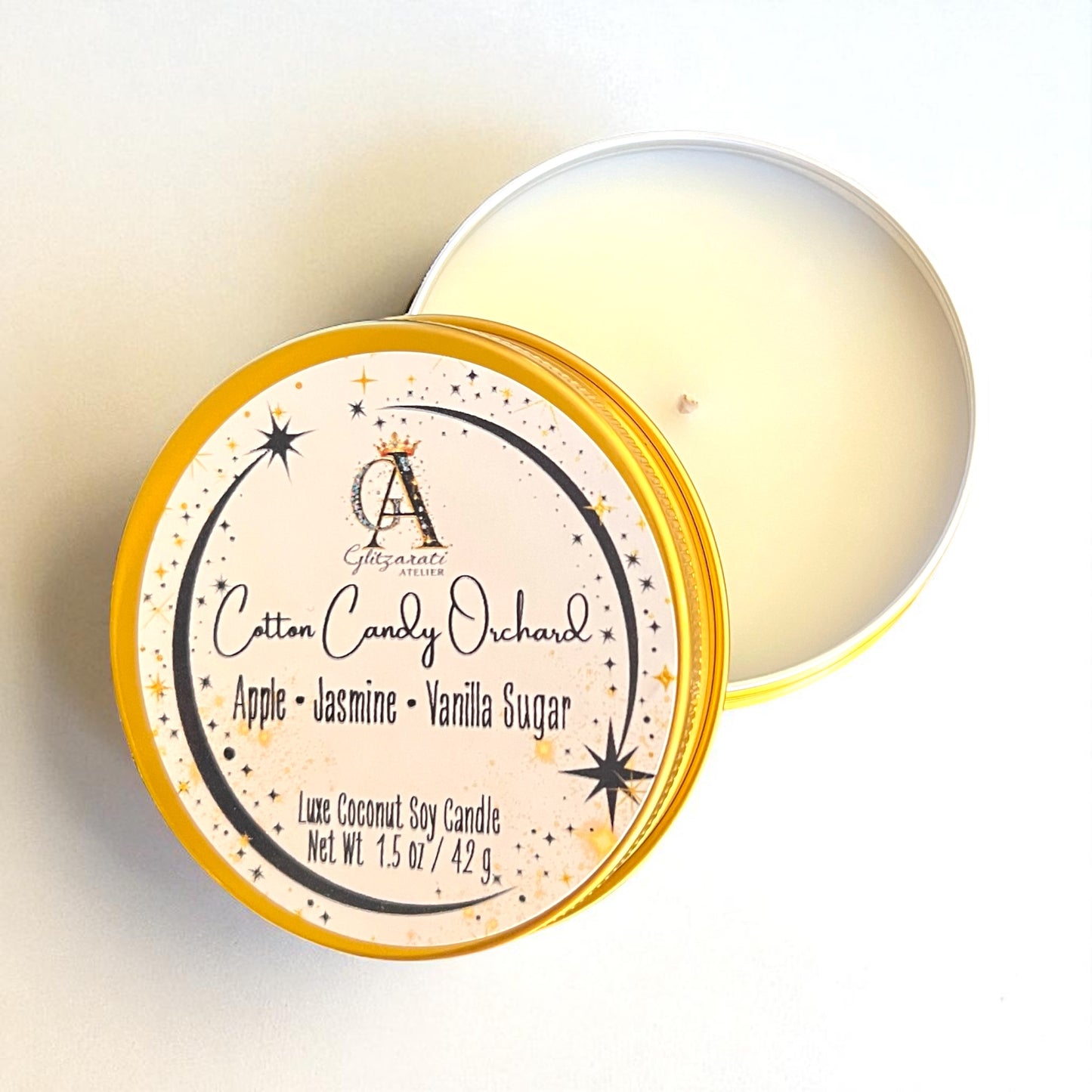 Candle in a tin with 'Cotton Candy Orchard' label on a light background