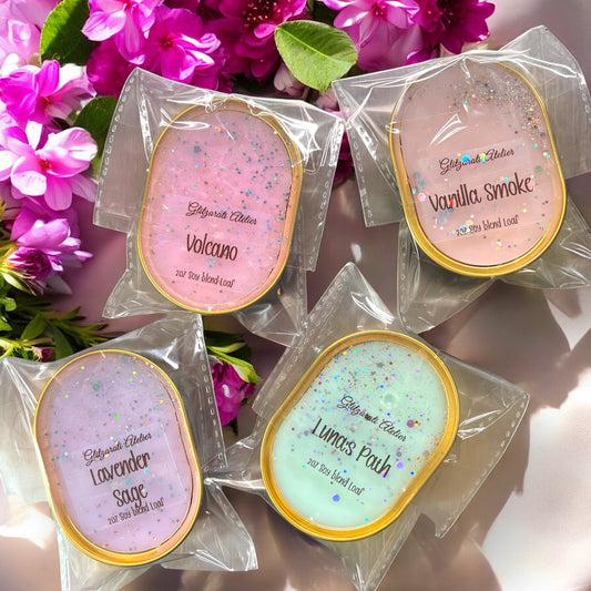 Four oval products in clear packaging with colorful labels against a floral background