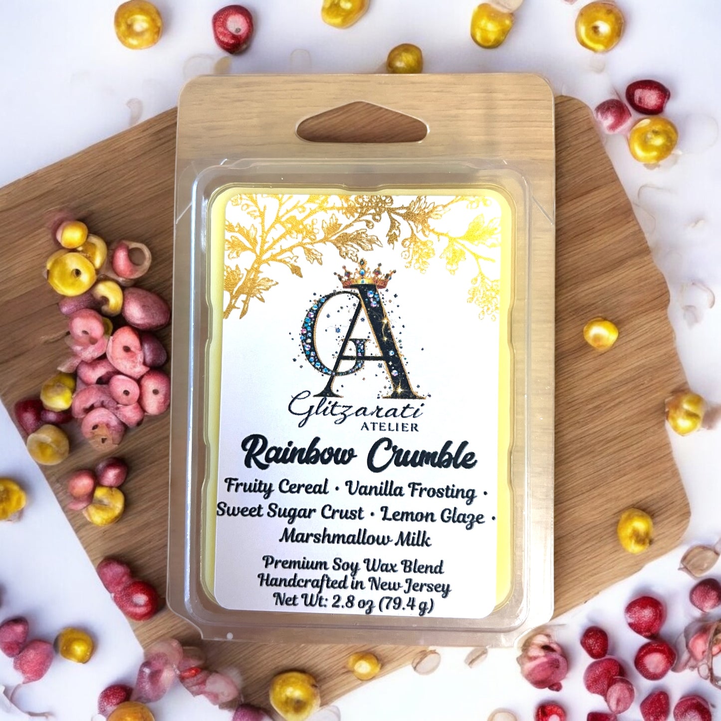 Giltazaris Rainbow Crumble wax melt packaging on a wooden board with colorful candies.