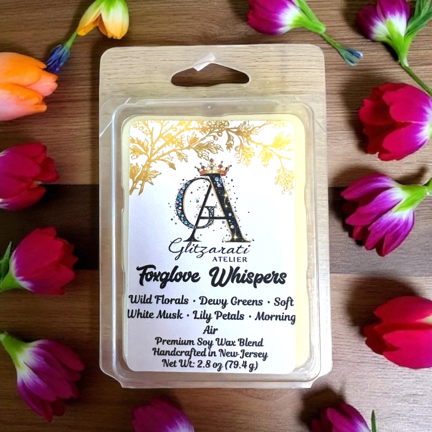 Soy wax melt package with floral design and product details on a wooden surface with flowers.