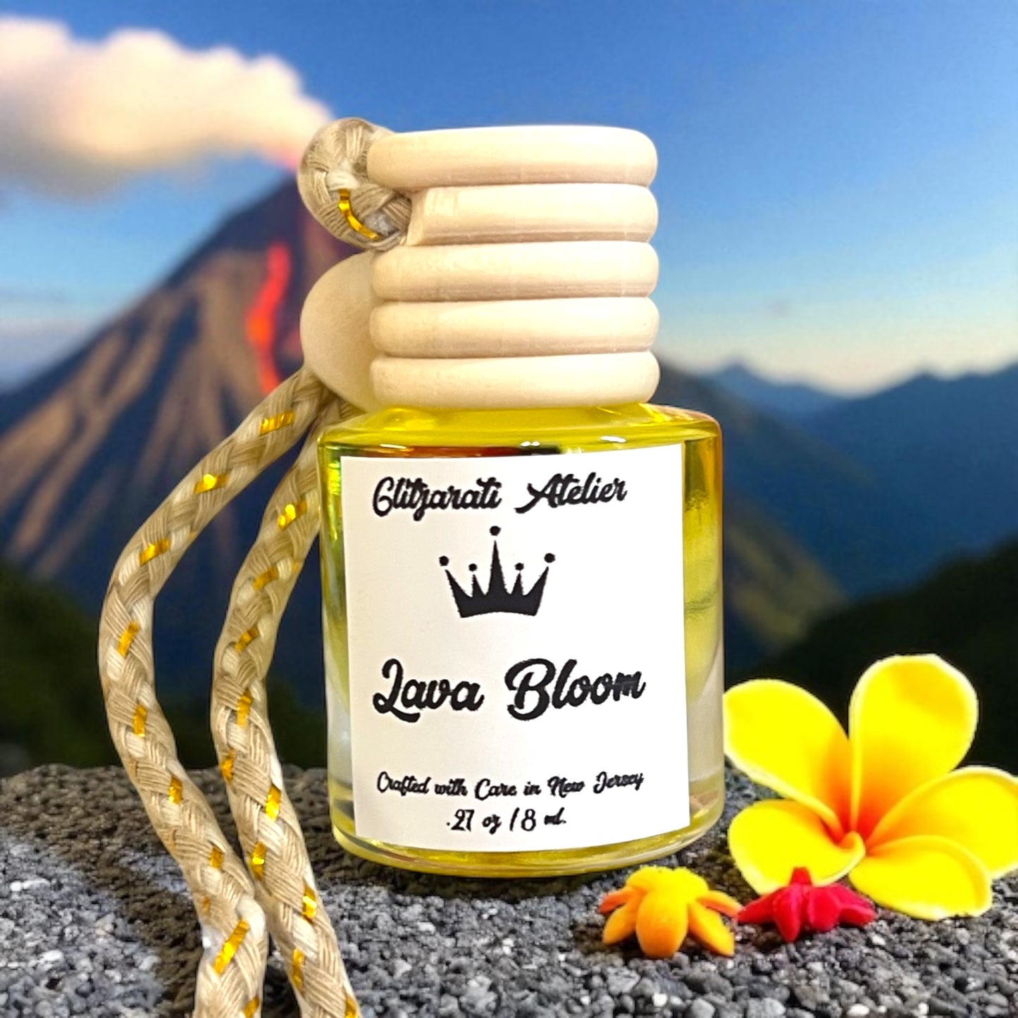 Car air freshener with 'Lava Bloom' label against a mountainous background