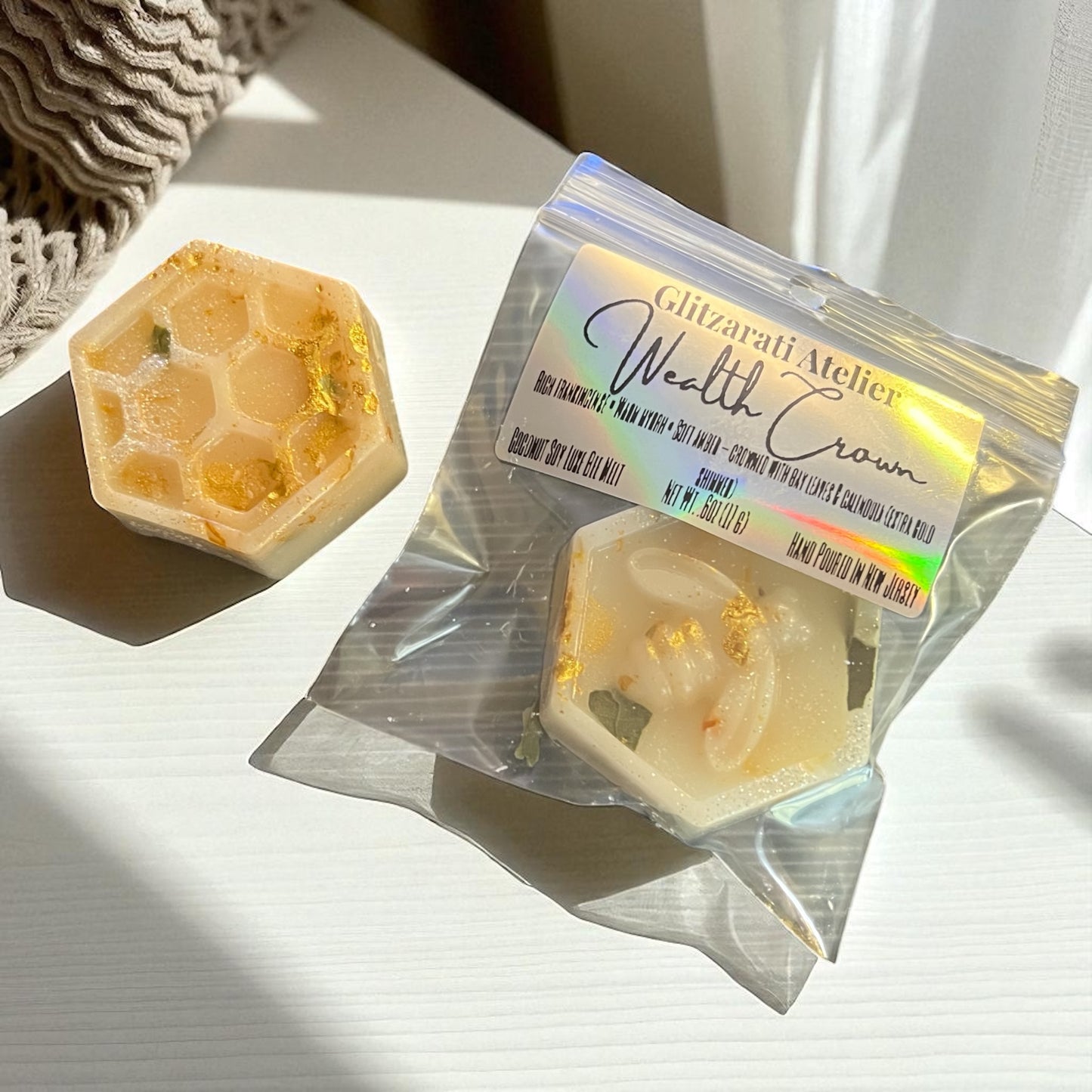 Hexagonal soap with a branded packaging on a light surface