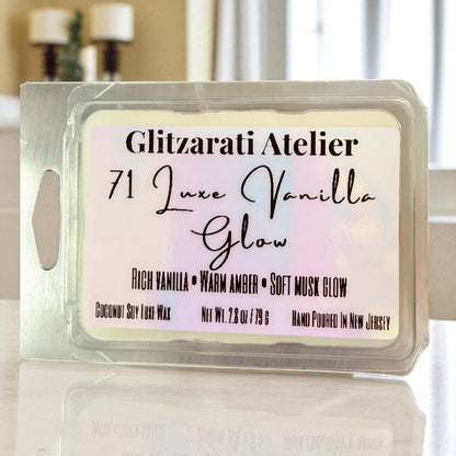 Wax melt package labeled 'Glitzarati Atelier 71 Luxe Vanilla Glow' on a reflective surface.