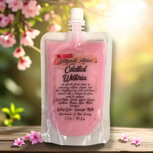 Pink pouch with text on a wooden surface with flowers in the background