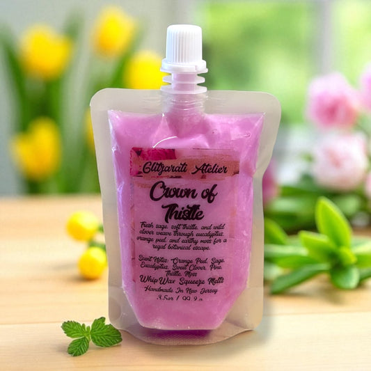Pink wax melt packaging with brand name on a wooden surface with blurred floral background