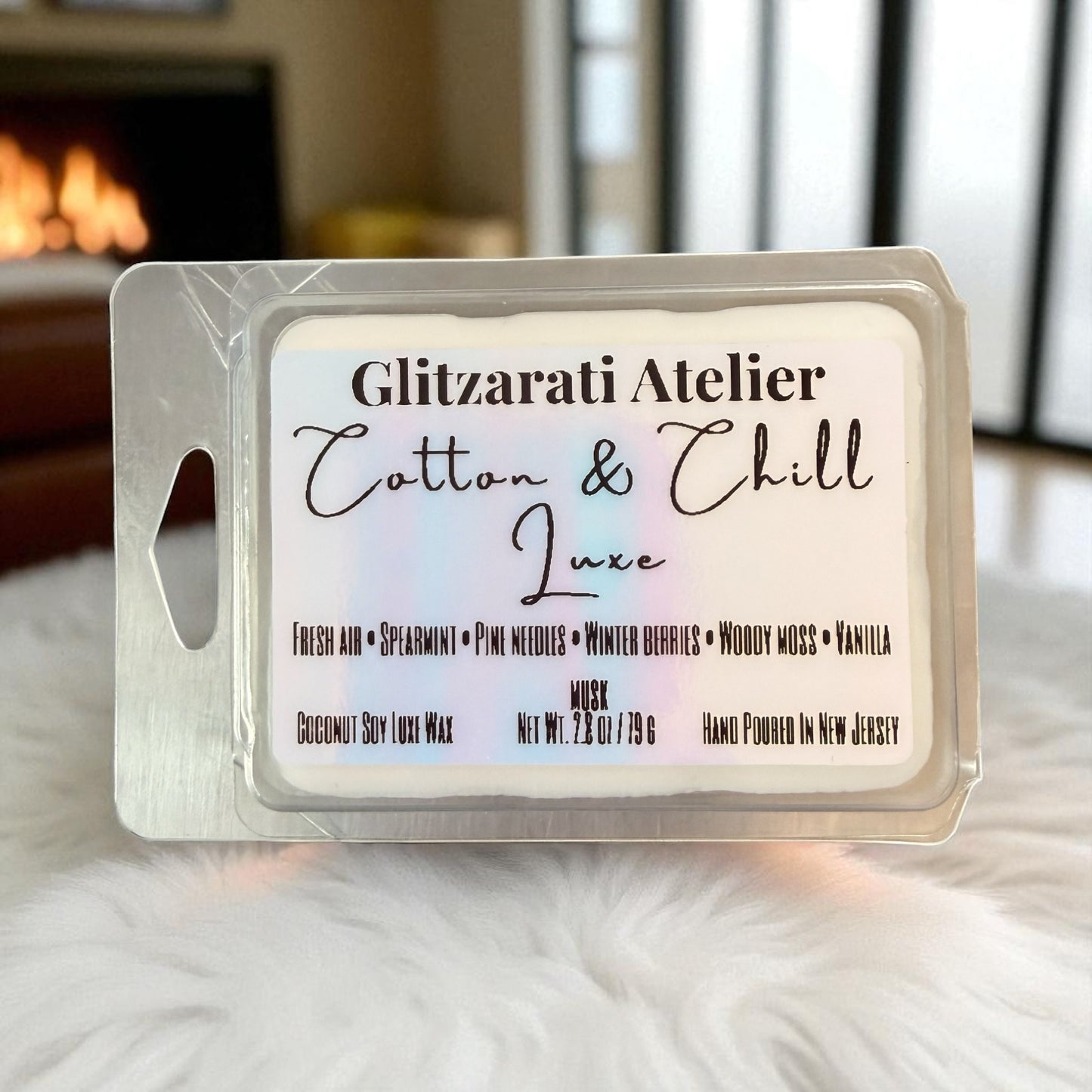 Wax melt packaging with 'Glitzerati Atelier Cotton & Chill Luxe' text on a soft surface.
