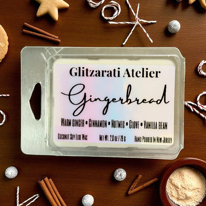 Gingerbread wax melt packaging with branding on a wooden surface with holiday decorations.