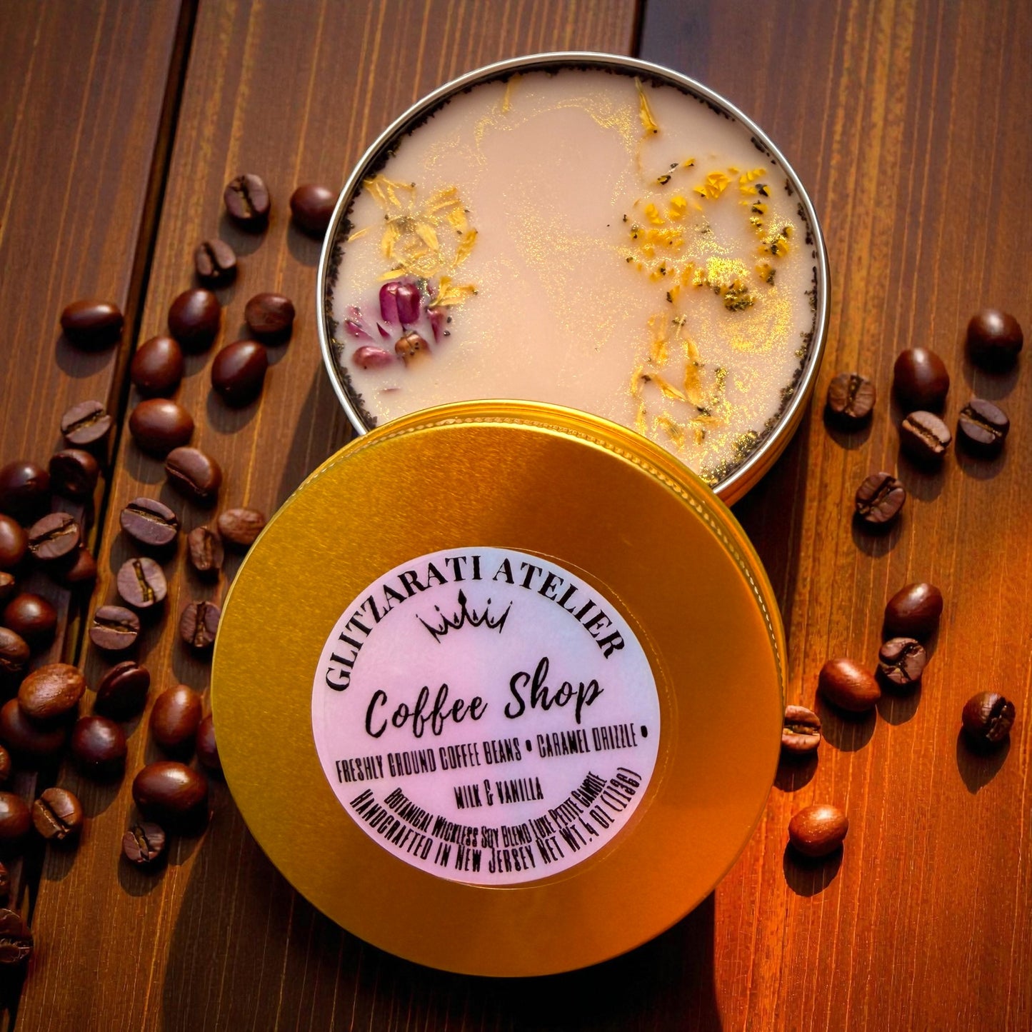 Candle in a tin with coffee beans on a wooden surface, featuring 'Gliptarati Atelier' label.