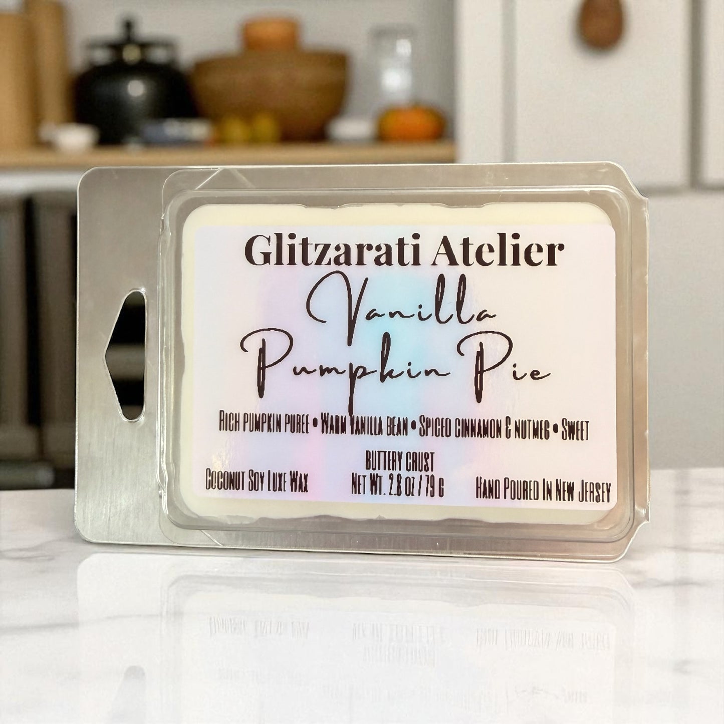Wax melt packaging with 'Vanilla Pumpkin Pie' description on a kitchen counter.