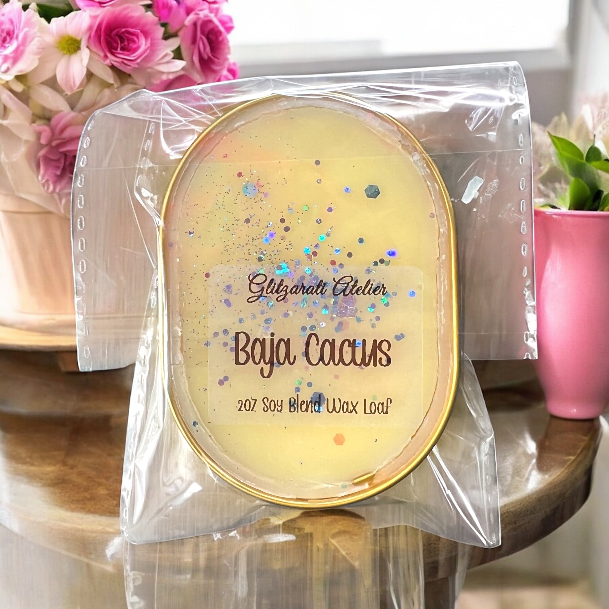 Scented wax melt in packaging with 'Gizgarati Atelier' branding on a decorative surface.