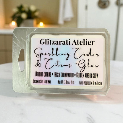 Wax melt packaging with 'Glitzarati Atelier' branding on a blurred bathroom background