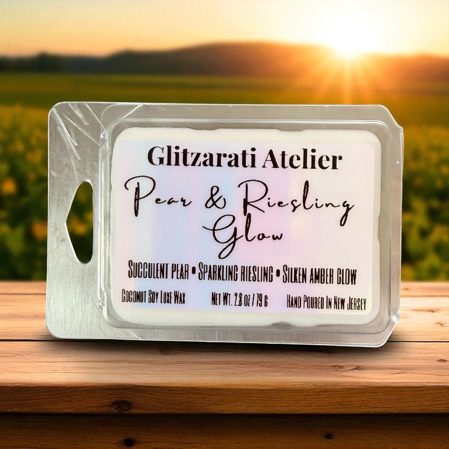 Wax melt package with 'Glitzerati Atelier' branding against a sunset background