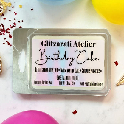 Packaged soap bar with 'Glitzerati Atelier Birthday Cake' label on a decorative background.