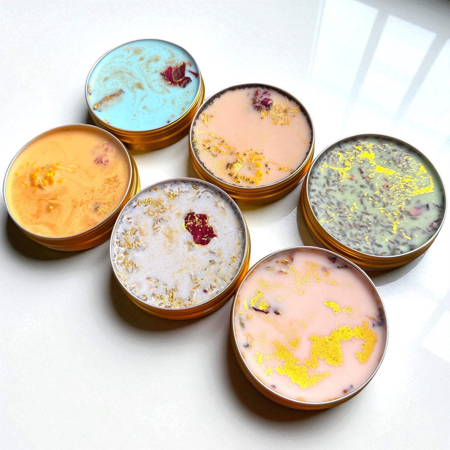 Set of colorful bath bombs with decorative elements on a white surface