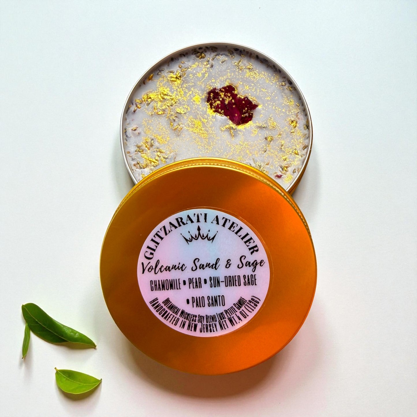 Open container of Volcanic Sand & Sage soap with a visible brand label on a white background