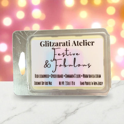 Wax melt packaging with 'Glitzarati Atelier' branding on a blurred lights background