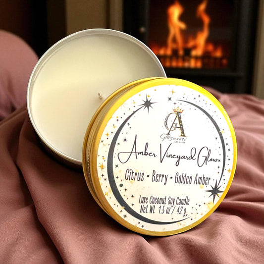 Candle in a tin with 'Amber Vineyard Glow' label against a warm background