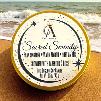 Candle tin labeled 'Sacred Serenity' on a beach with waves in the background