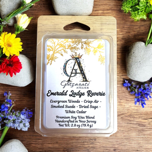 Guzarati Atelier wax melt packaging on a wooden surface with flowers and stones