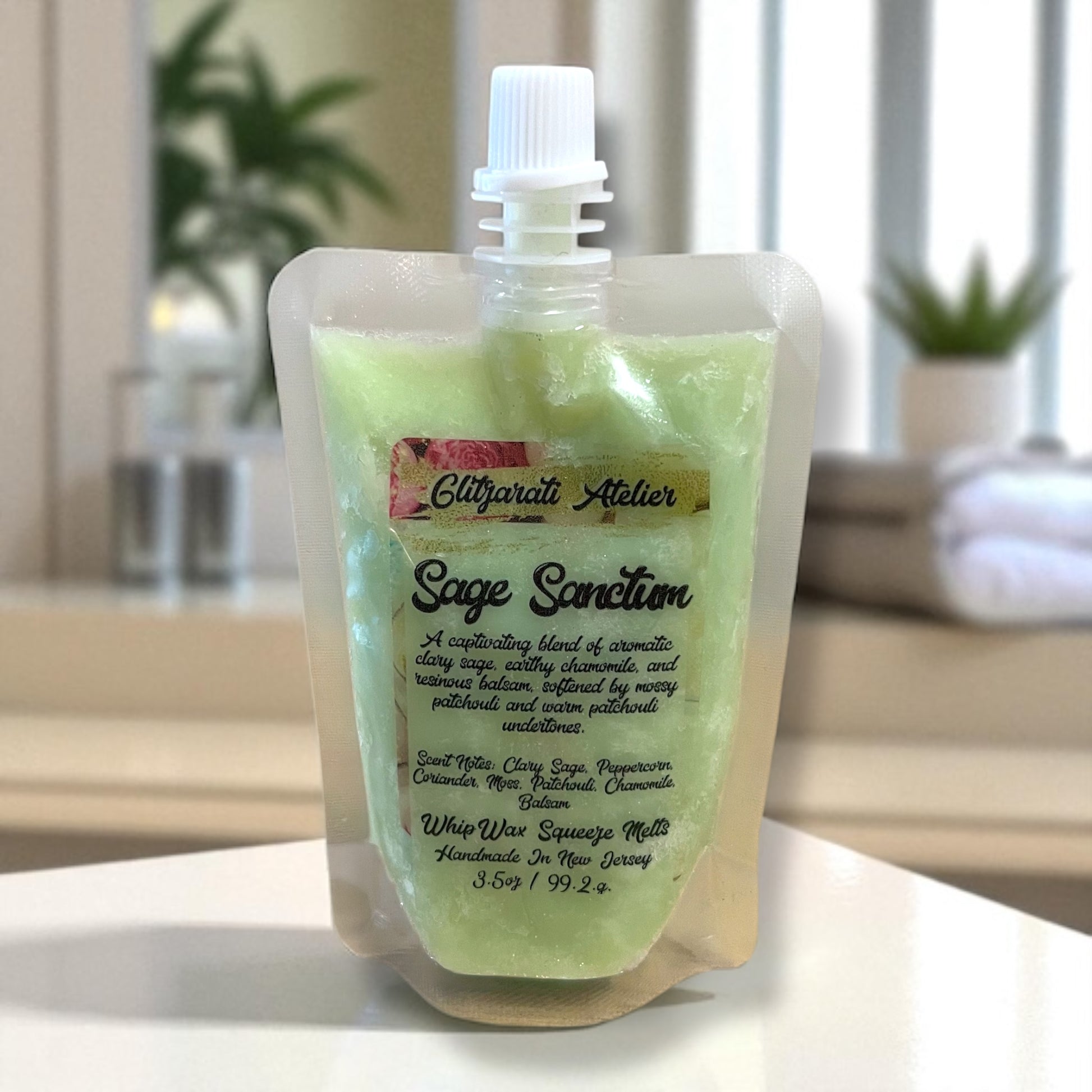 Sage Sanction soap in a clear packaging on a white surface with a blurred background