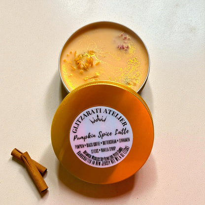 Pumpkin spice latte candle in a tin with a visible brand label on a light background