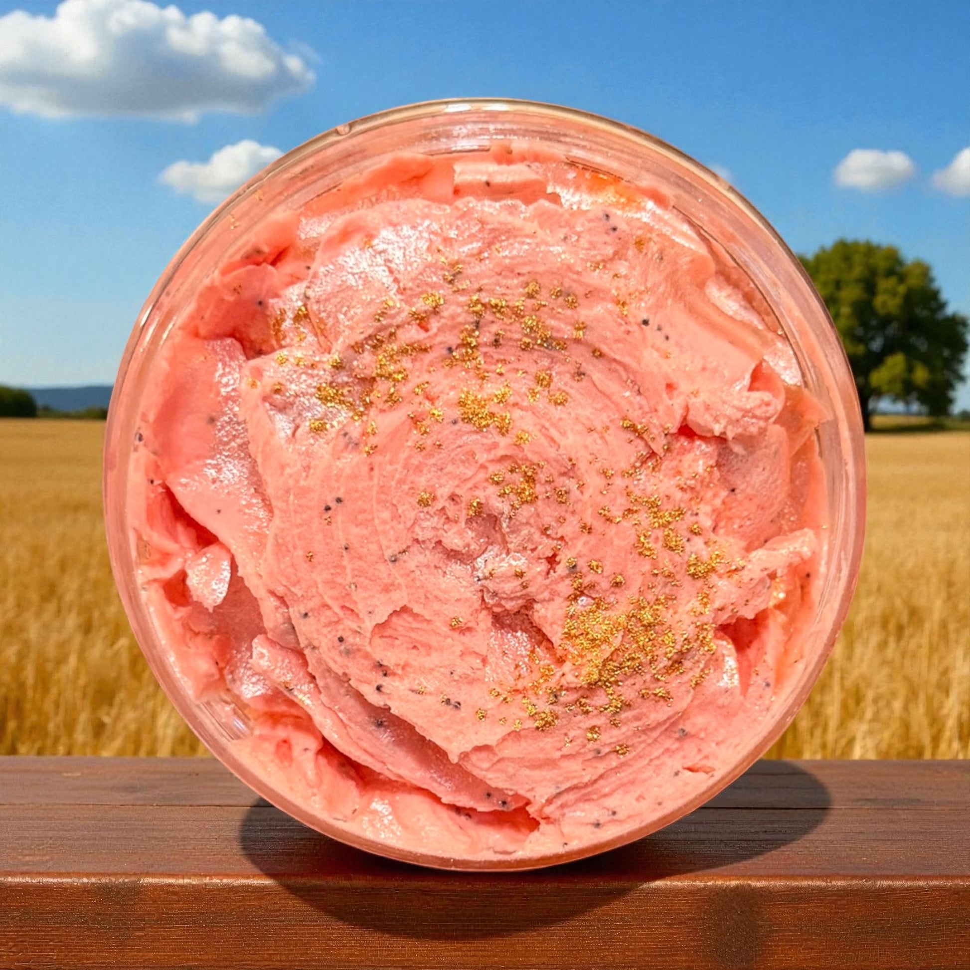 Pink ice cream in a container with a field and blue sky in the background