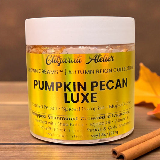 Jar of 'Pumpkin Pecan Luxe' cream with a cinnamon stick on a wooden surface