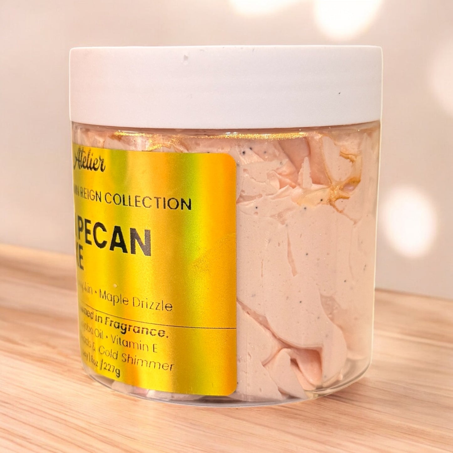 Jar of pecan-flavored bath salts with a yellow label on a wooden surface.