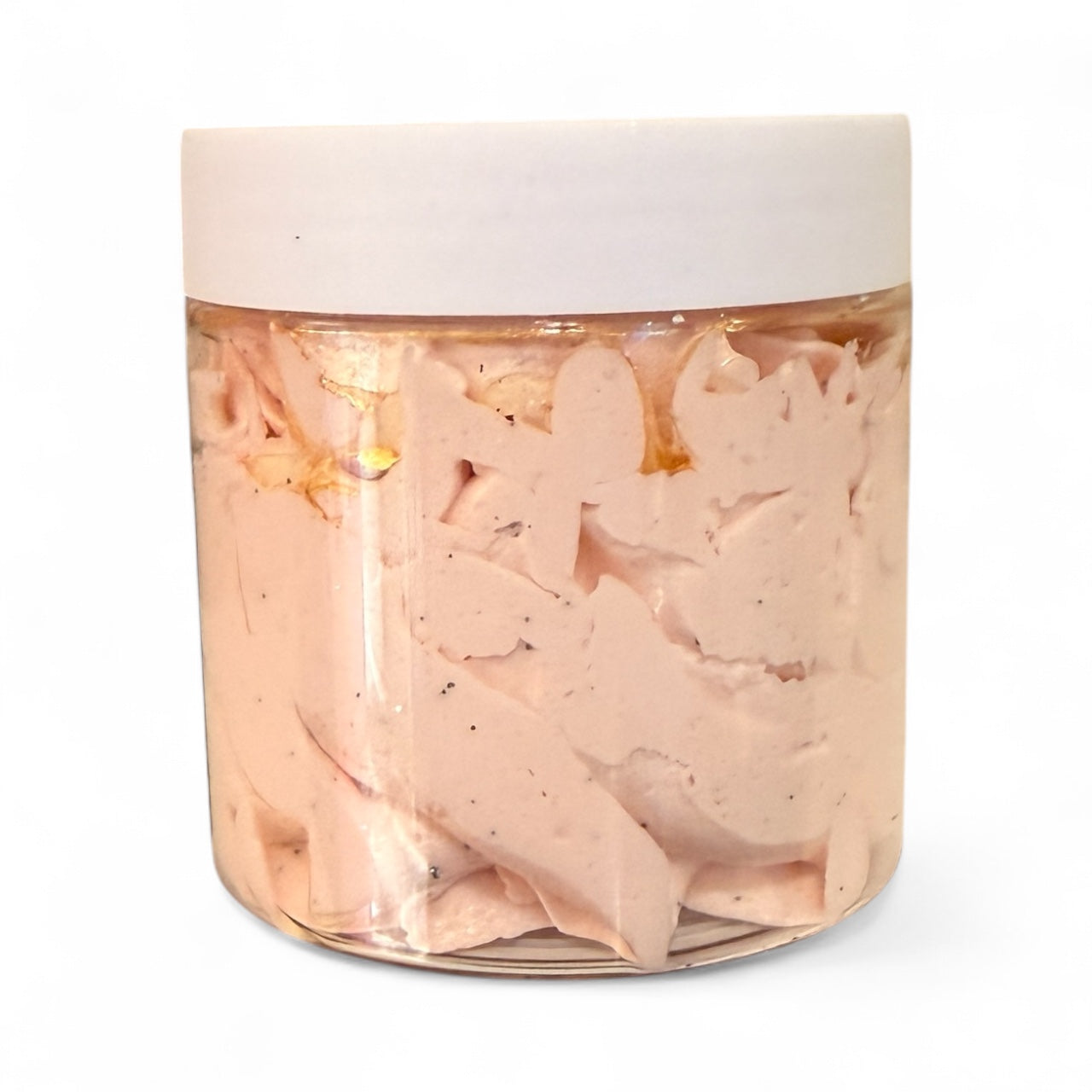 Jar of pink salad dressing with a white lid on a white background