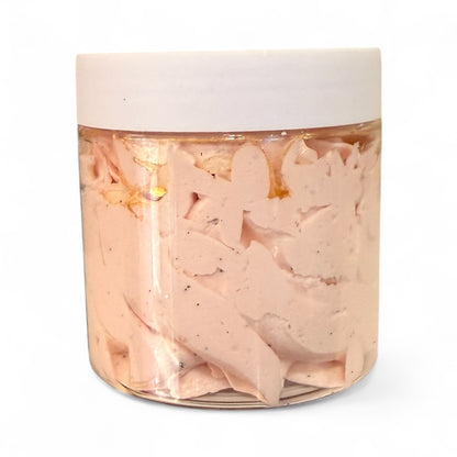 Jar of pink salad dressing with a white lid on a white background
