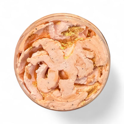 Pink cream with gold flakes in a container on a white background