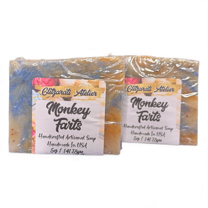 Two bars of 'Monkey Farts' soap with labels on a white background