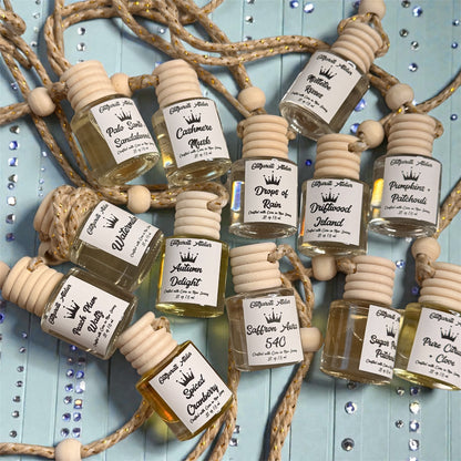 Small bottles of perfume with labels on a decorative background