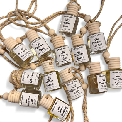 Set of small perfume bottles with wooden caps on a white background