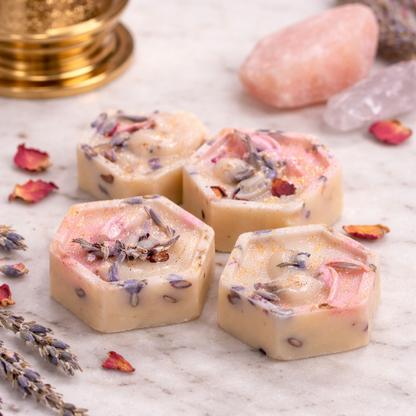 Hexagonal soap bars with lavender and rose petals on a marble surface
