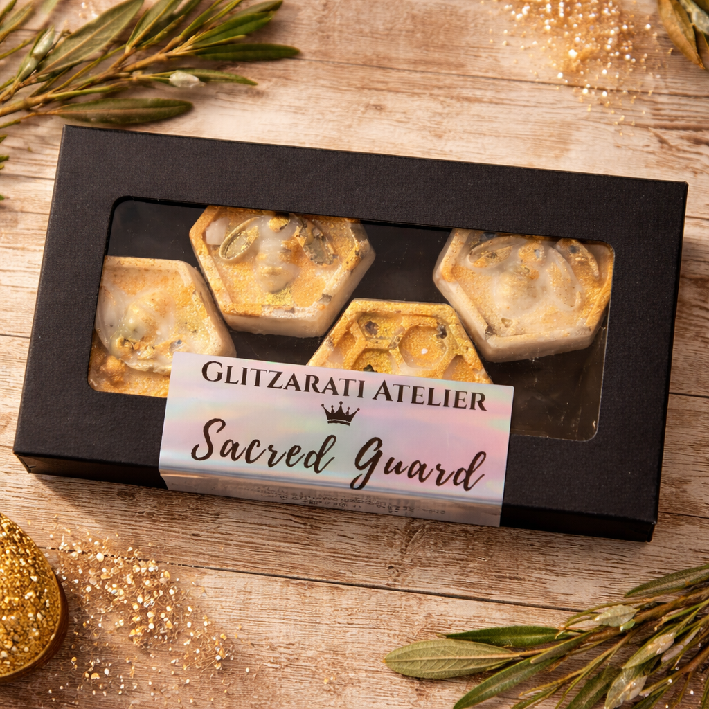 Box of 'Sacred Guard' products from Glitzarati Atelier on a wooden surface with decorative elements.