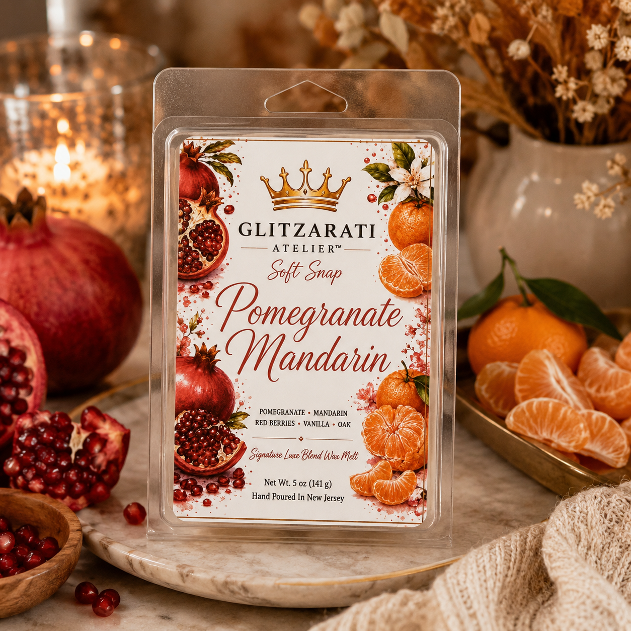 Glitzerati Atelier Pomegranate Mandarin wax melt package with pomegranates and mandarins on a decorative plate.