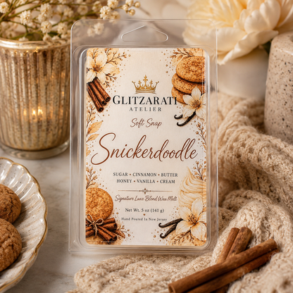 Glitzarati Atelier Snickerdoodle wax melt packaging with decorative elements on a warm-toned background.