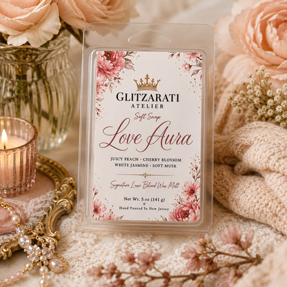 Wax melt packaging with floral design and 'Glitzarati Atelier' branding, surrounded by decorative items.
