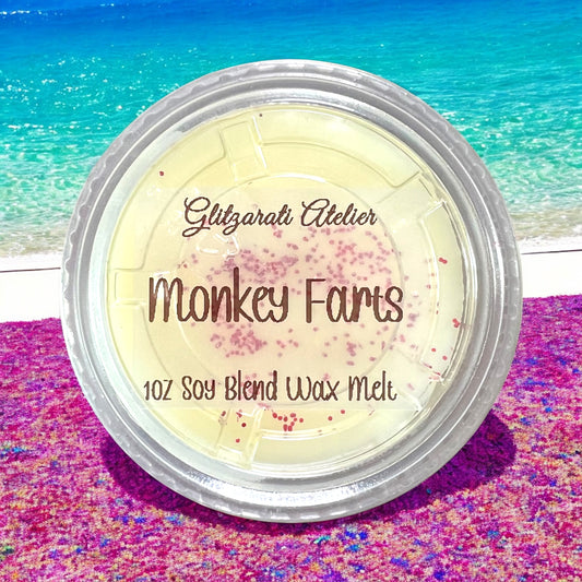 Soy blend wax melt container with 'Glitzerati Atelier' branding on a beach background