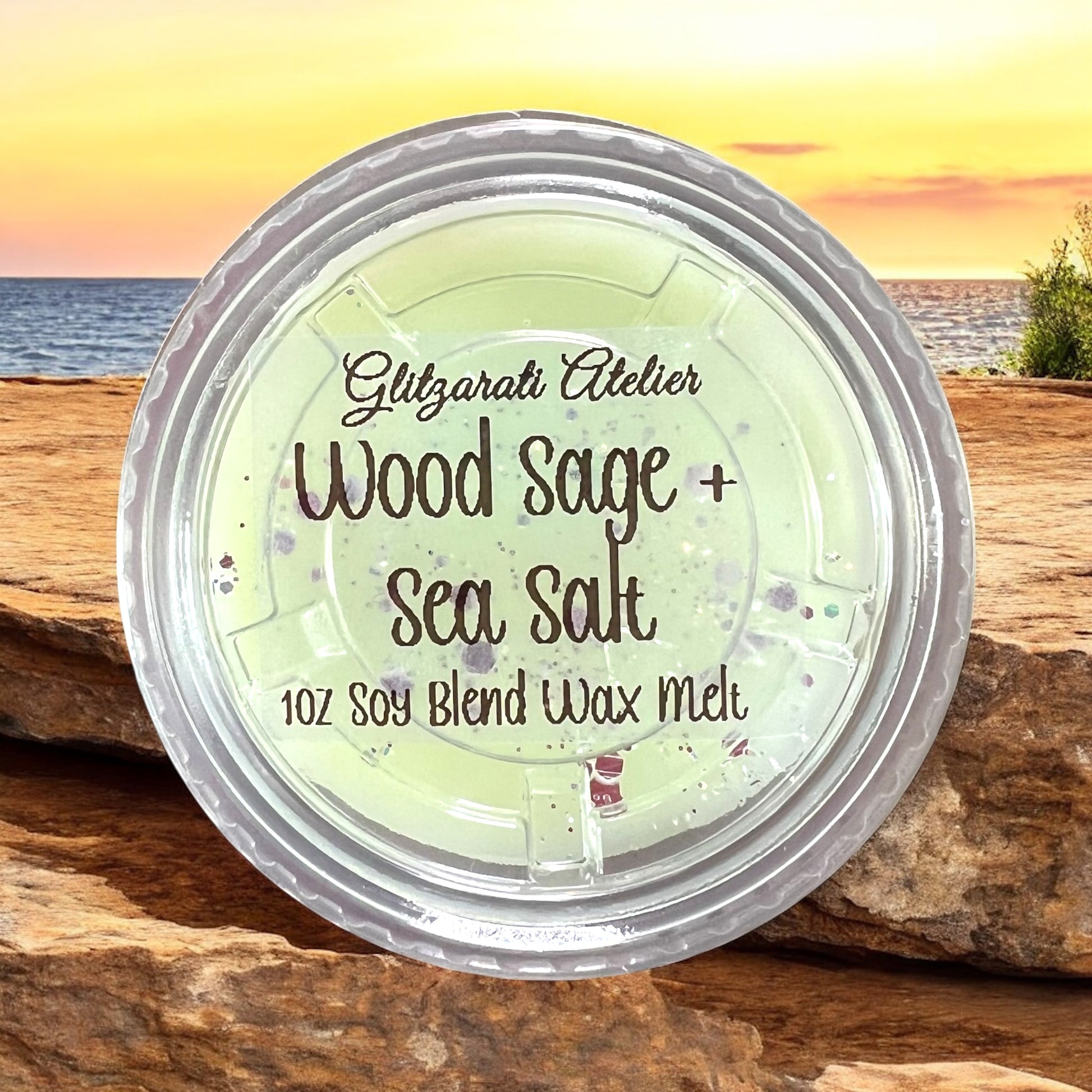 Wood Sage + Sea Salt wax melt container with a scenic background