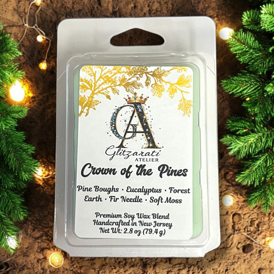 Wax melt package with 'Crown of the Pines' description on a decorative background with lights and greenery.