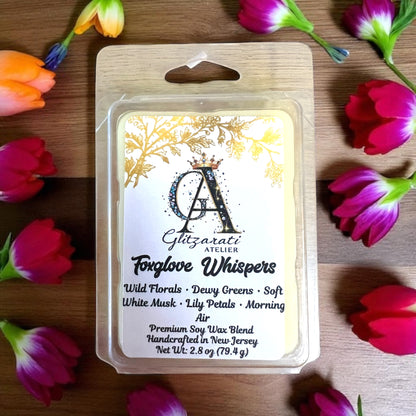 Soy wax melt package with floral design and product details on a wooden surface with flowers.