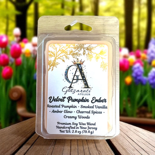 Gltizarati Atelier velvet pumpkin amber wax melt packaging with a blurred floral background