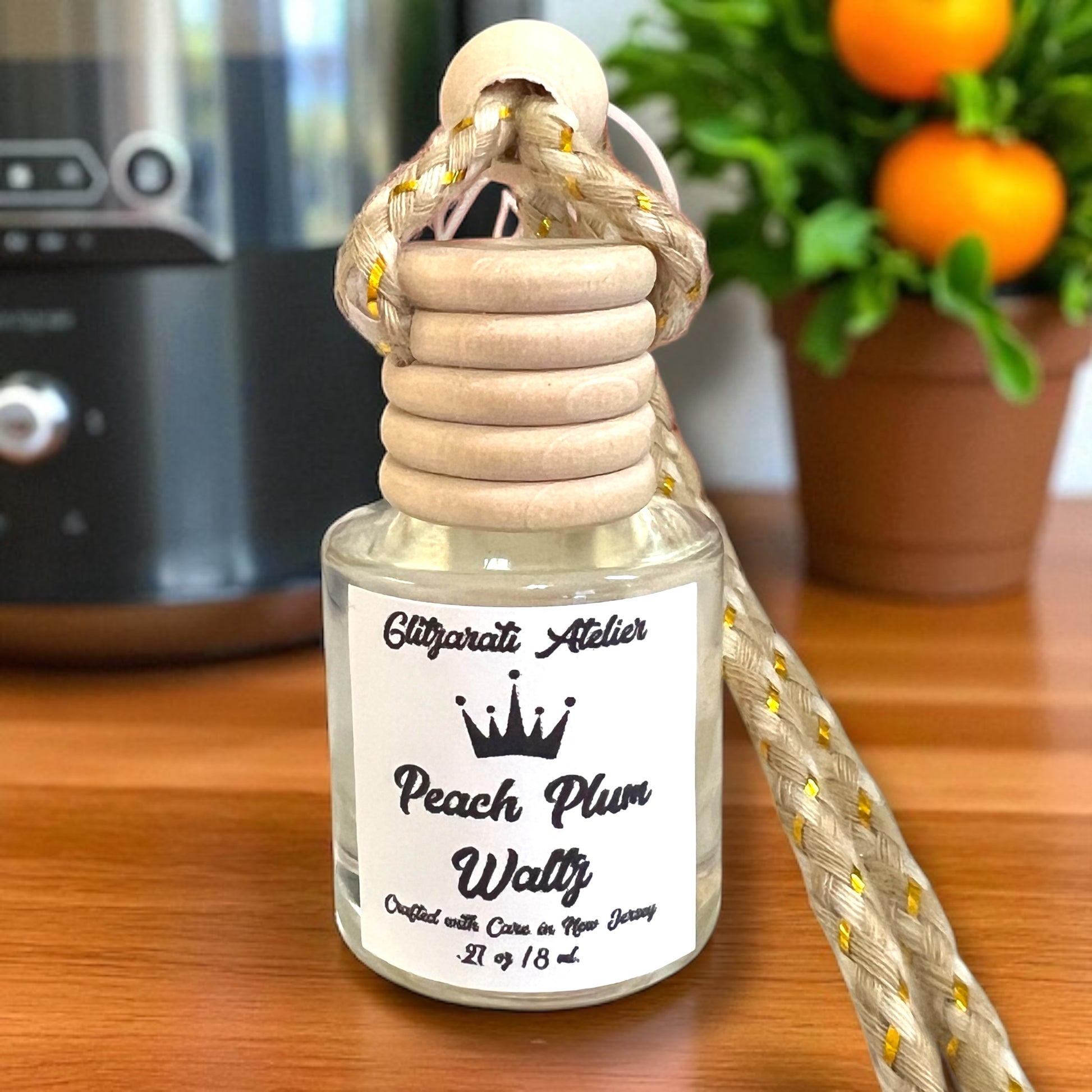 Perfume bottle with wooden top on a wooden surface, with a blurred background