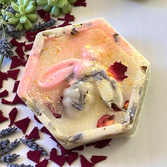 Hexagonal soap with floral and lavender petals on a white background