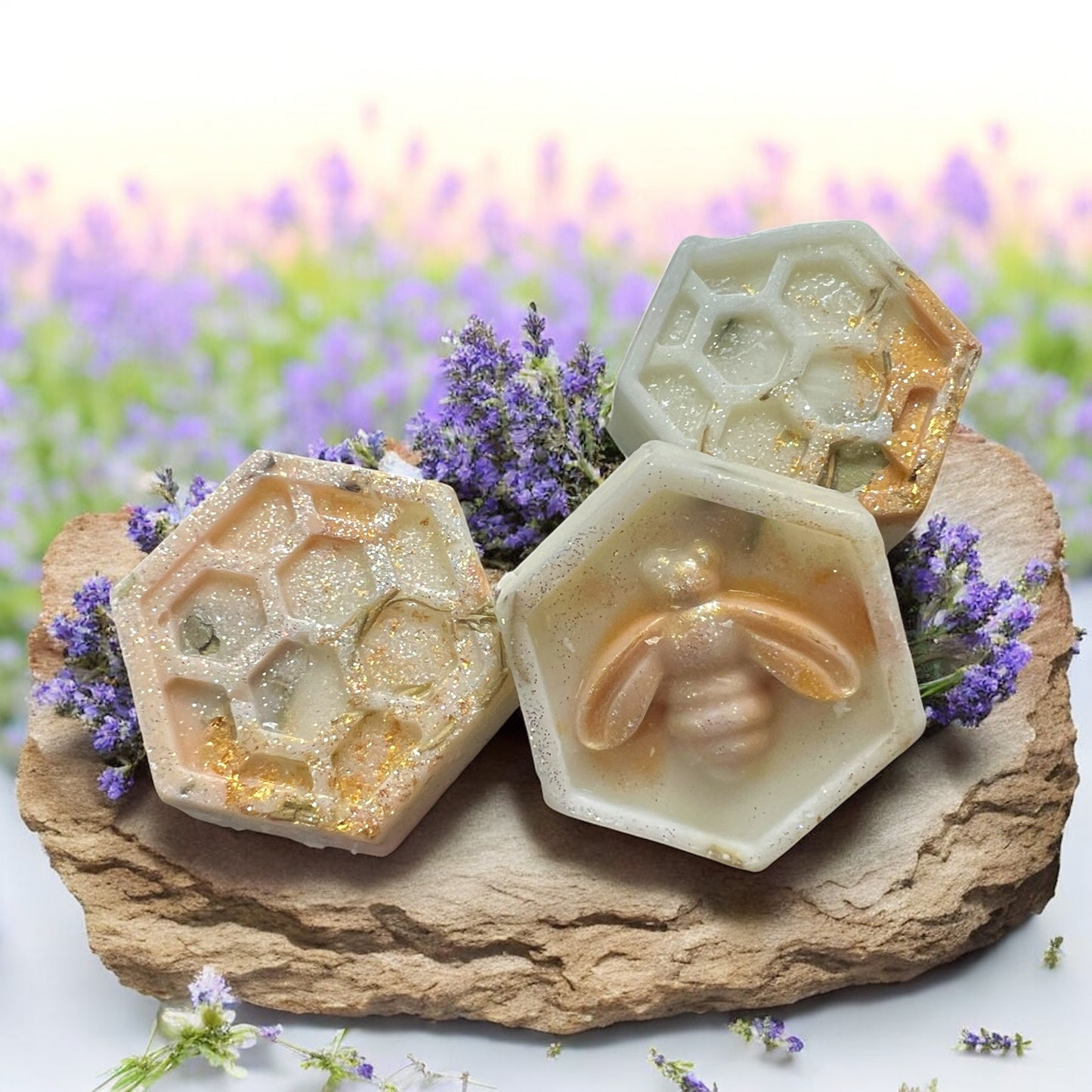 Hexagonal honeycomb-shaped soap with bee design on a stone surface with lavender flowers in the background