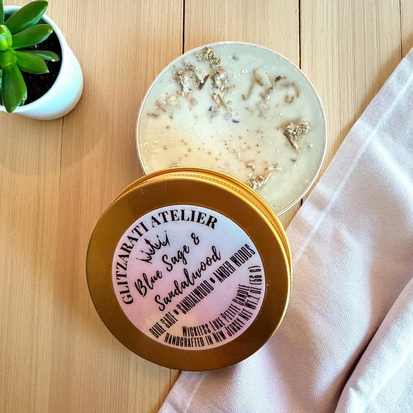 Jar of body scrub with a gold lid on a wooden surface