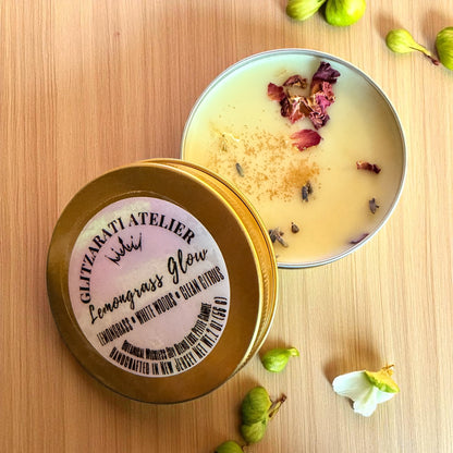 Candle in a tin with decorative elements on a wooden surface