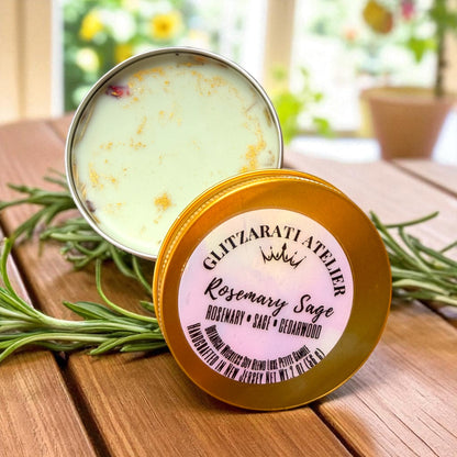 Rosemary Sage balm in a tin with a visible brand label on a wooden surface.